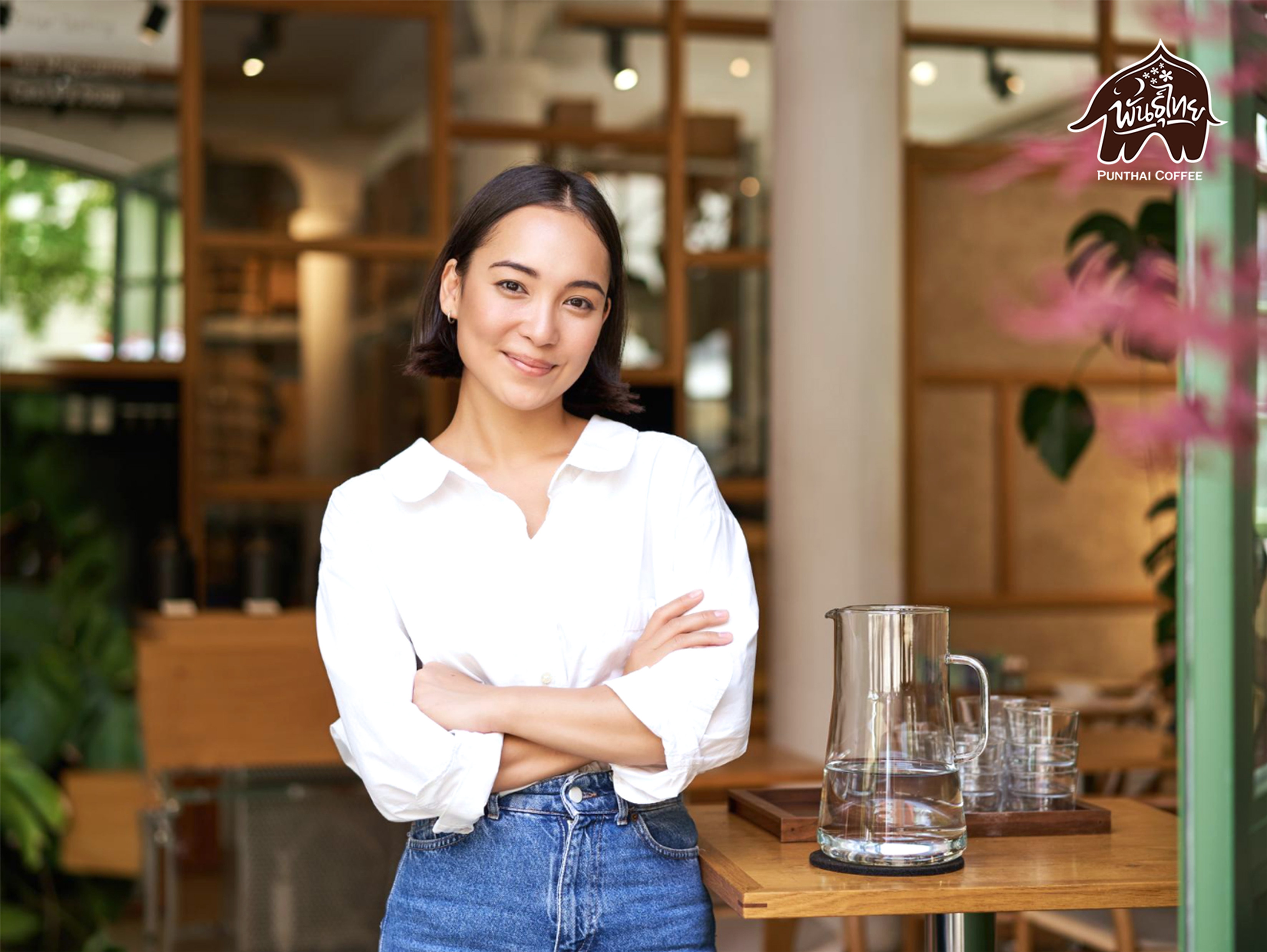 A woman stands in front of coffee shop