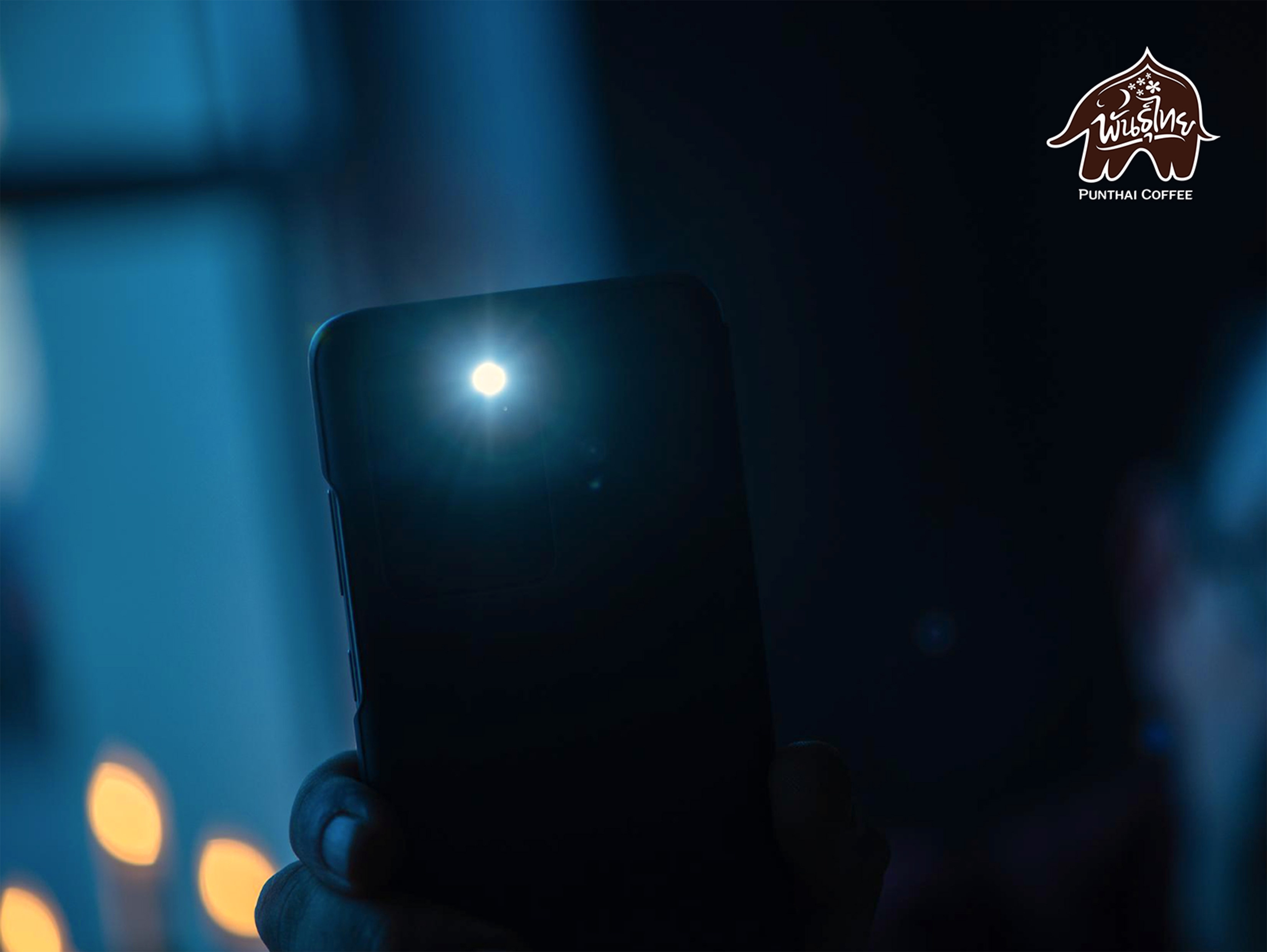 hand holding phone with flashlight